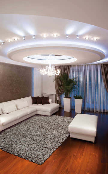 Living room with white sectional and Nourison Zen Grey Shag Rug on hardwood floors.
