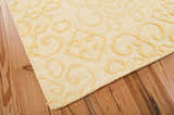 Close-up of the beige Nourison Ambrose Linen rug showing wool texture and raised scroll pattern.