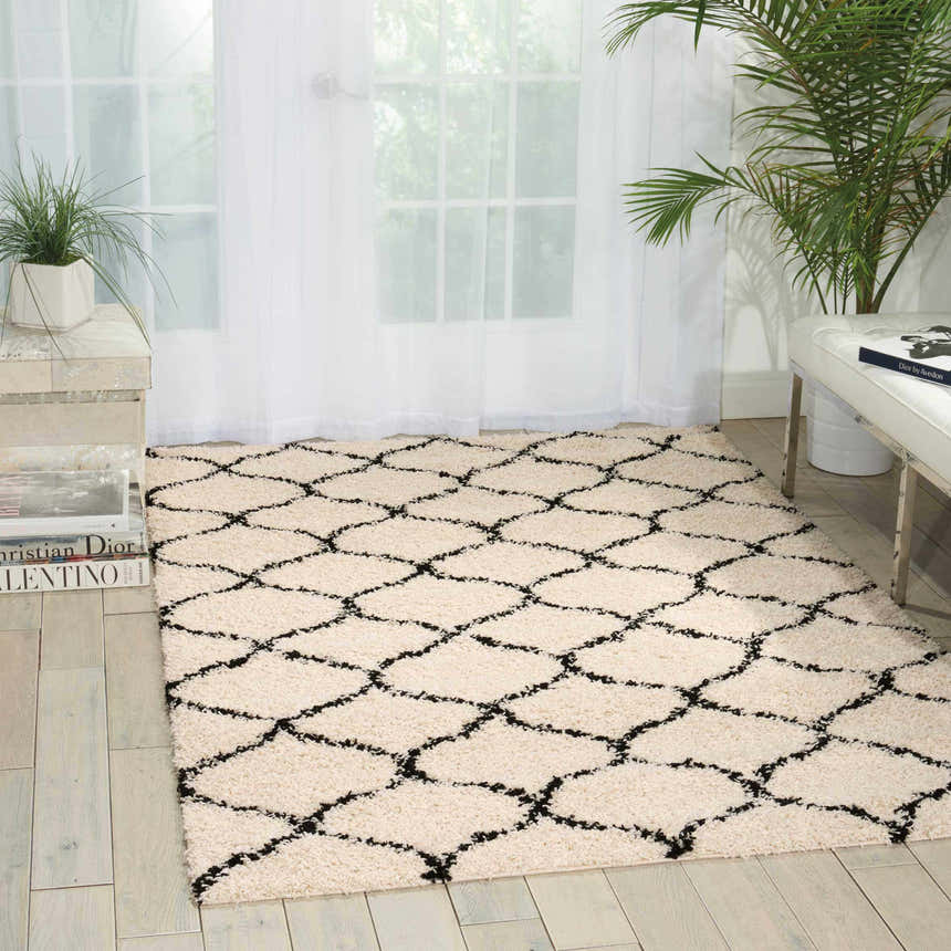 Bright room scene with Nourison Windsor Ivory Shag rug, chestnut diamond pattern, white bench, and potted plants.