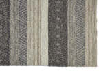 Close-up of Feizy Berkeley Transitional Stripes Area Rug. Hand-woven wool rug in gray, taupe, and tan with a textured, striped design. Corner