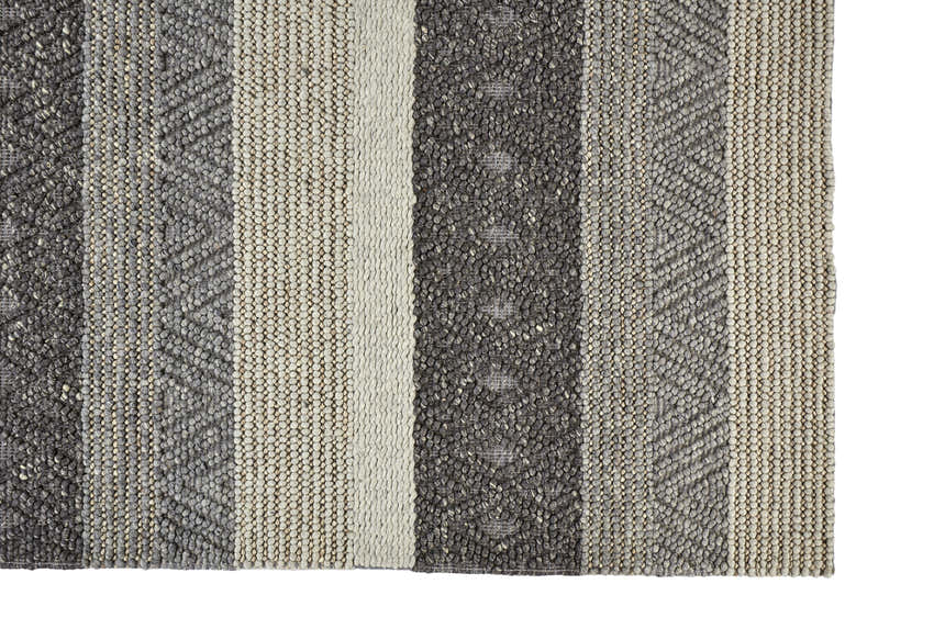 Close-up of Feizy Berkeley Transitional Stripes Area Rug. Hand-woven wool rug in gray, taupe, and tan with a textured, striped design. Corner