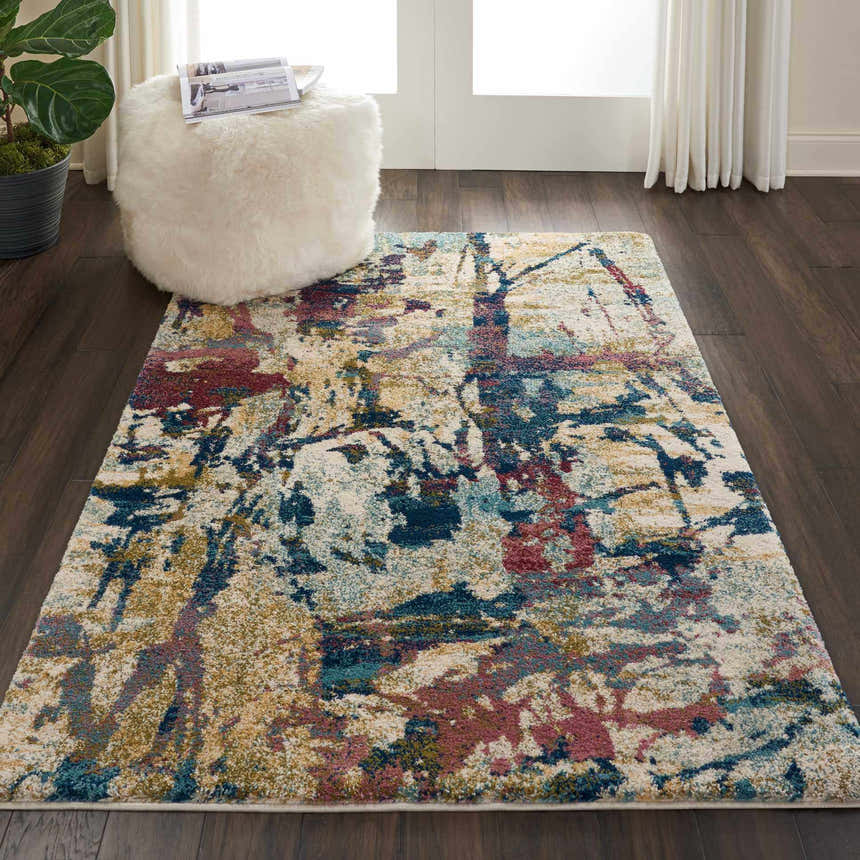 Living room scene with Nourison Fusion Cream Multicolor rug, white ottoman, dark wood floors.