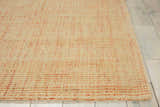 Close-up of the handmade Barclay Butera Intermix Wheat area rug. Peach tones and wool texture visible.