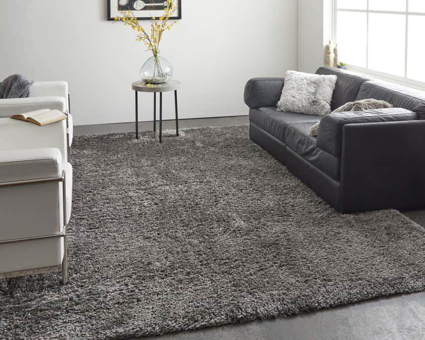 Modern living room with black sofa and white chairs featuring the Feizy Darian Gray Area Rug. Roomscene-Rectangle