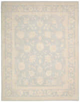 Close-up of the Nourison Zephyr Light Blue rug, featuring a floral pattern and border in soft, muted tones.