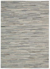 Close-up of the handmade Nourison Capelle Silver rug. Features a textured, horizontal stripe design in gray and cream.