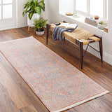 Hallway scene with a Vahn Area Rug runner in light pink, blue, and ivory. Bench with plants and books. Roomscene-Runner