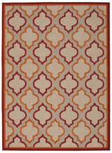 Close-up of Nourison Aloha Red Outdoor Area Rug featuring a quatrefoil pattern in red and orange on a neutral background.