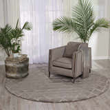 Modern living room with grey Nourison Twilight rug, armchair, and plants.