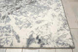 Close up of the Nourison Maxell Grey rug showing its abstract gray and white pattern and soft texture.