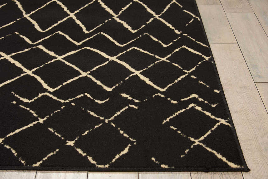Close up of the Nourison Grafix Black Bohemian rug showing the geometric diamond pattern.