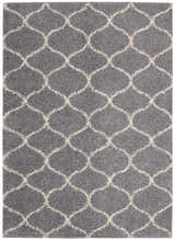Close-up of the Nourison Windsor Silver Shag Rug, featuring a gray shag pile and a cream-colored Moroccan trellis pattern.