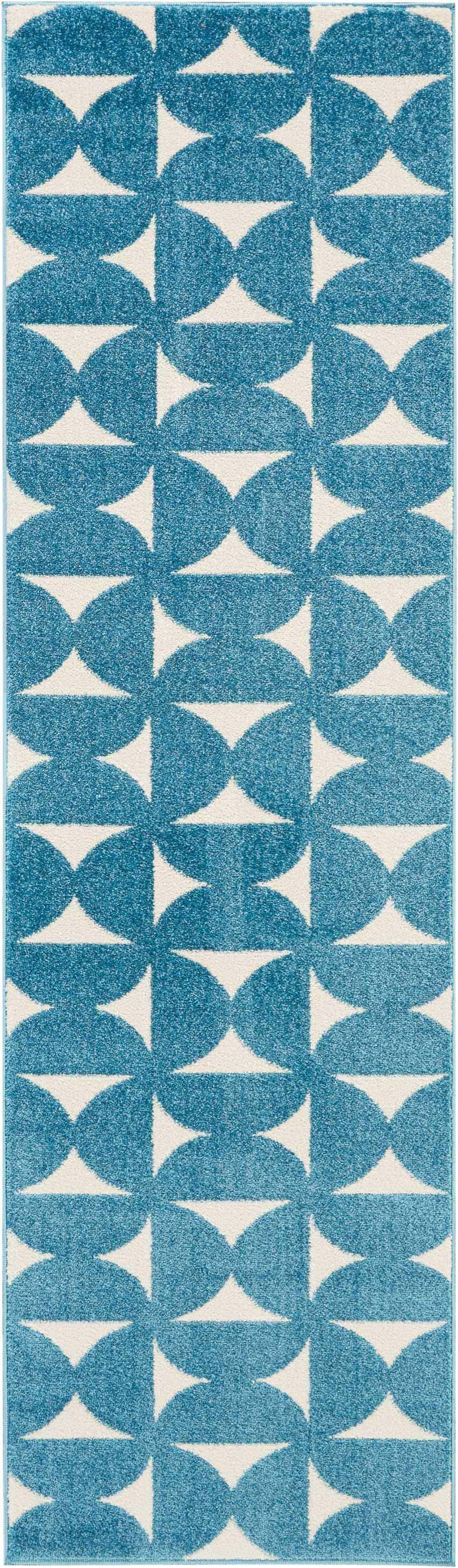 Close-up of Nourison Harper Blue rug, featuring a geometric pattern of blue semi-circles and white triangles.
