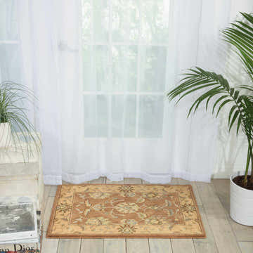 Bright room scene with Nourison Persian Empire Mocha Persian rug, plants, and sheer curtains.