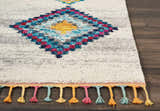 Close up of the Nourison Nomad Cream Grey Tribal Rug, featuring colorful diamond pattern and tassels.