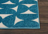 Close up of the Nourison Harper Blue rug. Colorful geometric pattern on a textured light blue rug.