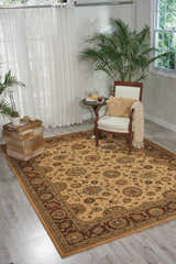 Sunlit room with Nourison Living Treasures Beige Traditional Indoor Area Rug, chair, and plants.