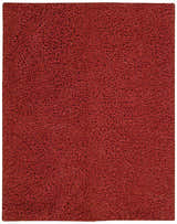 Close-up of the Nourison Zen Red Shag Rug showing its dense, soft texture and rich red color. Handmade shag rug detail.