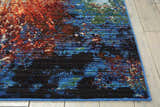 Close-up of the Nourison Chroma Red Flare rug, featuring a modern abstract design with red, blue, and black hues.