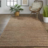 Living room scene with a Feizy Kaelani brown and gray rug, woven chair, plants, and wood floors. Roomscene-Rectangle