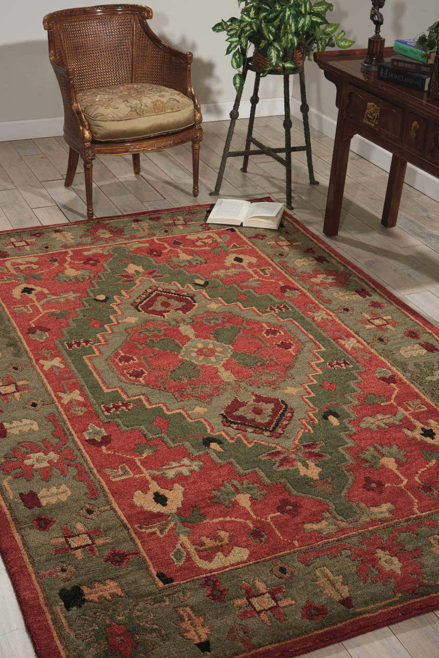 Traditional living room with a Nourison Tahoe Rust rug, wood chair, plant stand, and console table.