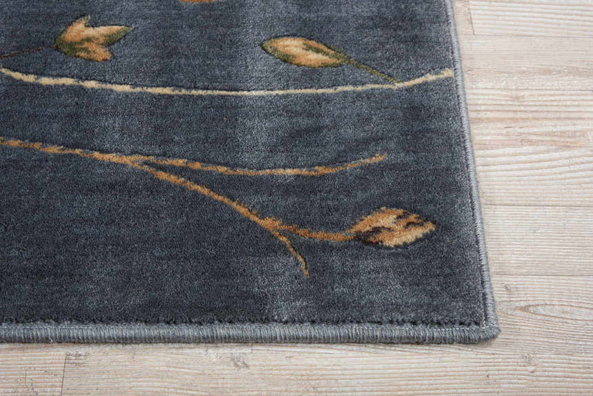 Close-up of the Nourison Cambridge Light Blue Floral rug, featuring a detailed flower and branch pattern.
