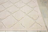 Close-up of the Michael Amini Gleam Ivory rug, showcasing its diamond pattern and soft texture on a light wood floor.