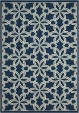 Close-up of the Nourison Caribbean Navy Contemporary Area Rug featuring a geometric floral pattern in navy, light blue, and cream.