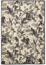 Close-up of Waverly Vintage Lux Graphite rug. Modern design with a graphite floral pattern on a light background.
