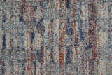 Close-up of Feizy Edgemont rug. Abstract design with blue, ivory, and orange yarns creating a textured, casual pattern. Texture