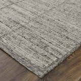 Close up of the Feizy Navaro rug. Gray, ivory, and taupe hand woven wool rug with a casual, contemporary design. Corner