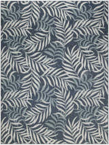 Close-up of the Nourison Garden Oasis Navy Tropical Area Rug featuring a dense leaf pattern in navy, white, and gray.