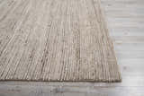 Close-up of the Nourison OCEAN Sand area rug, showing its textured, striated design and sandstone color.