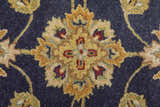 Close up of the Feizy Wagner rug showing the blue, gold, and red traditional floral pattern. Texture