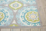 Close-up of the Waverly Sun N' Shade Jade rug. Features a coastal-inspired medallion pattern in jade, blue, grey, and white.
