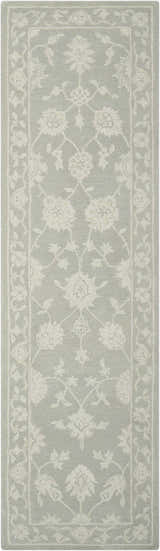 Close-up of the Nourison Zephyr Light Taupe rug. Features an ivory floral pattern and border on a light taupe wool texture.