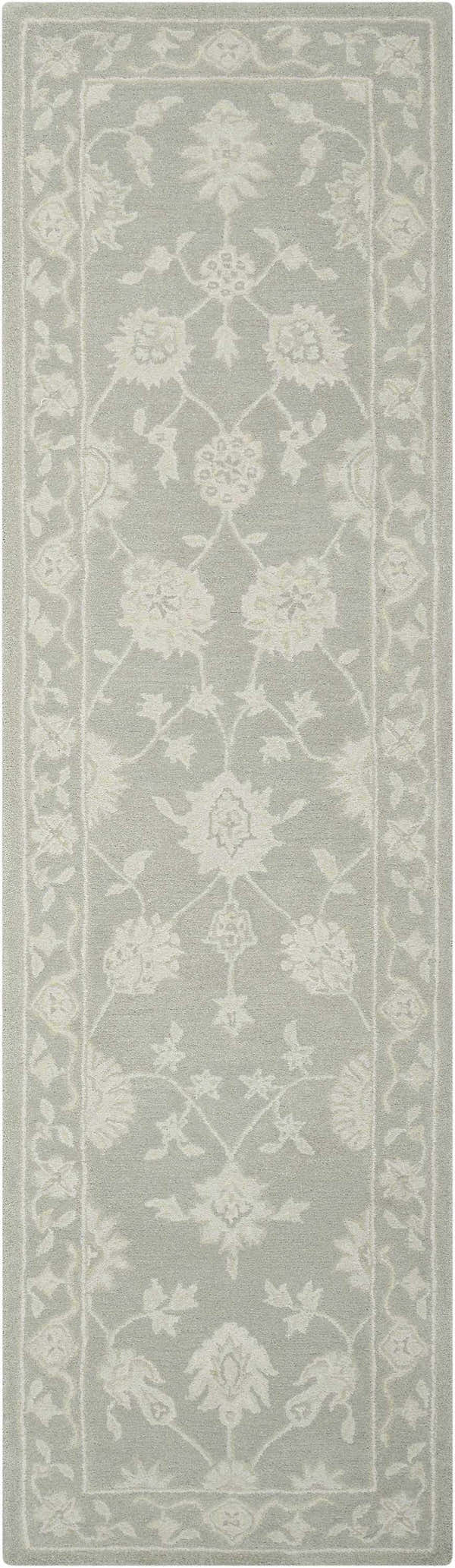 Close-up of the Nourison Zephyr Light Taupe rug. Features an ivory floral pattern and border on a light taupe wool texture.