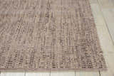 Close-up of the handmade Barclay Butera Intermix Smoke area rug. Gray wool rug with a subtle textured pattern.