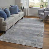 Living room scene with a Feizy Cadiz Taupe/Gray/Silver Area Rug, sofa, armchair, and wood floors. Roomscene-Rectangle