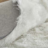 Close-up of the plush, white Feizy Indochine rug showing texture and backing. Fold