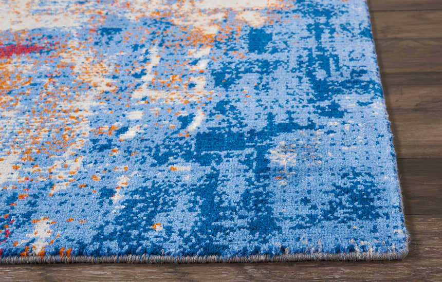Close-up of Nourison Twilight Ivory Multicolor rug with blue, orange, and white abstract pattern and soft texture.