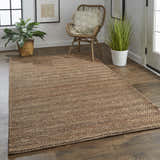 Entryway with Feizy Kaelani brown jute rug, wood floors, rattan chair, and potted plants for a natural, transitional style. Roomscene-Rectangle
