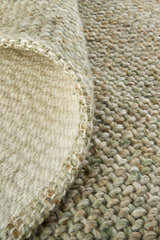 Close-up of the hand-woven Feizy Naples Green/Tan Area Rug showing texture and detail. Polyester rug with casual style. Fold