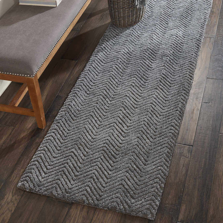 Grey runner rug styled on dark wood floors with a bench. Nourison Deco Mod Grey Modern Indoor Area Rug.