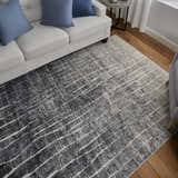 Living room scene with a Feizy Kano black, gray, and ivory rug under a white sofa with blue pillows. Roomscene-Rectangle