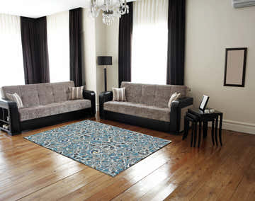 Living room scene with Feizy Brixton blue, ivory, and taupe geometric rug, sofas, wood floors, and neutral walls. Roomscene-Rectangle