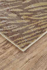 Close up of the Feizy Cannes Brown/Tan rug showing its animal print pattern and jute backing. Corner