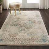 Living room scene with Nourison Fusion Cream Farmhouse rug, dark wood floors, and a furry stool.