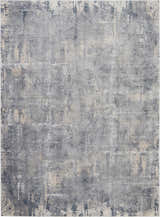 Close-up of the Nourison Rustic Textures Grey Beige area rug showing its distressed, mid-century modern design and textured surface.