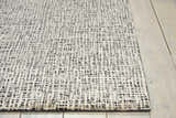 Close-up of Nourison Starlight Midnight rug showing the abstract black and white pattern and luxcelle texture.